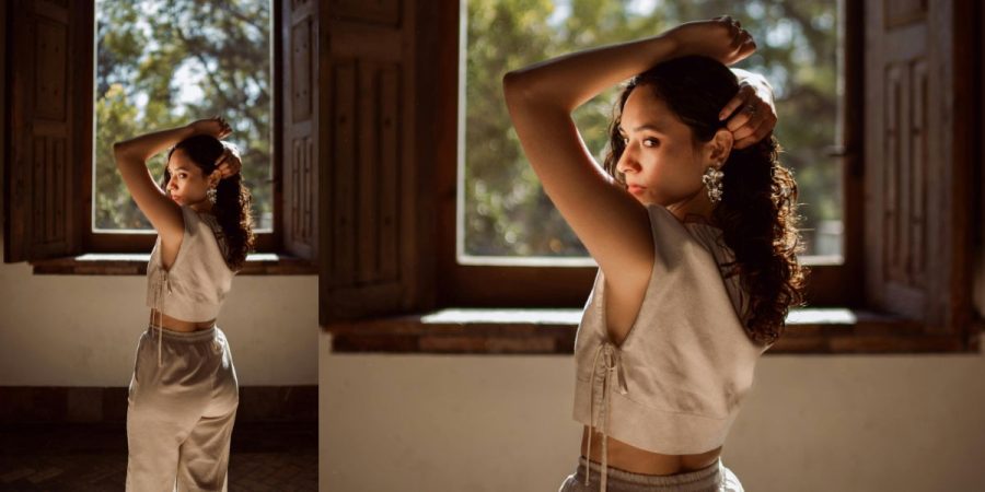 A person in hyper-feminine, 'cottagecore' fashion, to celebrate queer femininity.