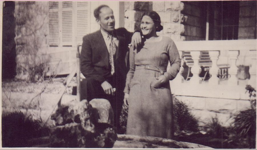 An archival photo of two adult siblings smiling next to each other.