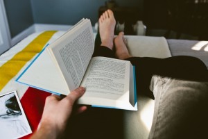 Man reads book in bed