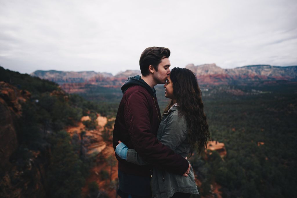 Couple kissing on a hiking trail
