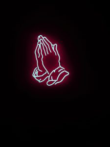 Neon sign of praying hands