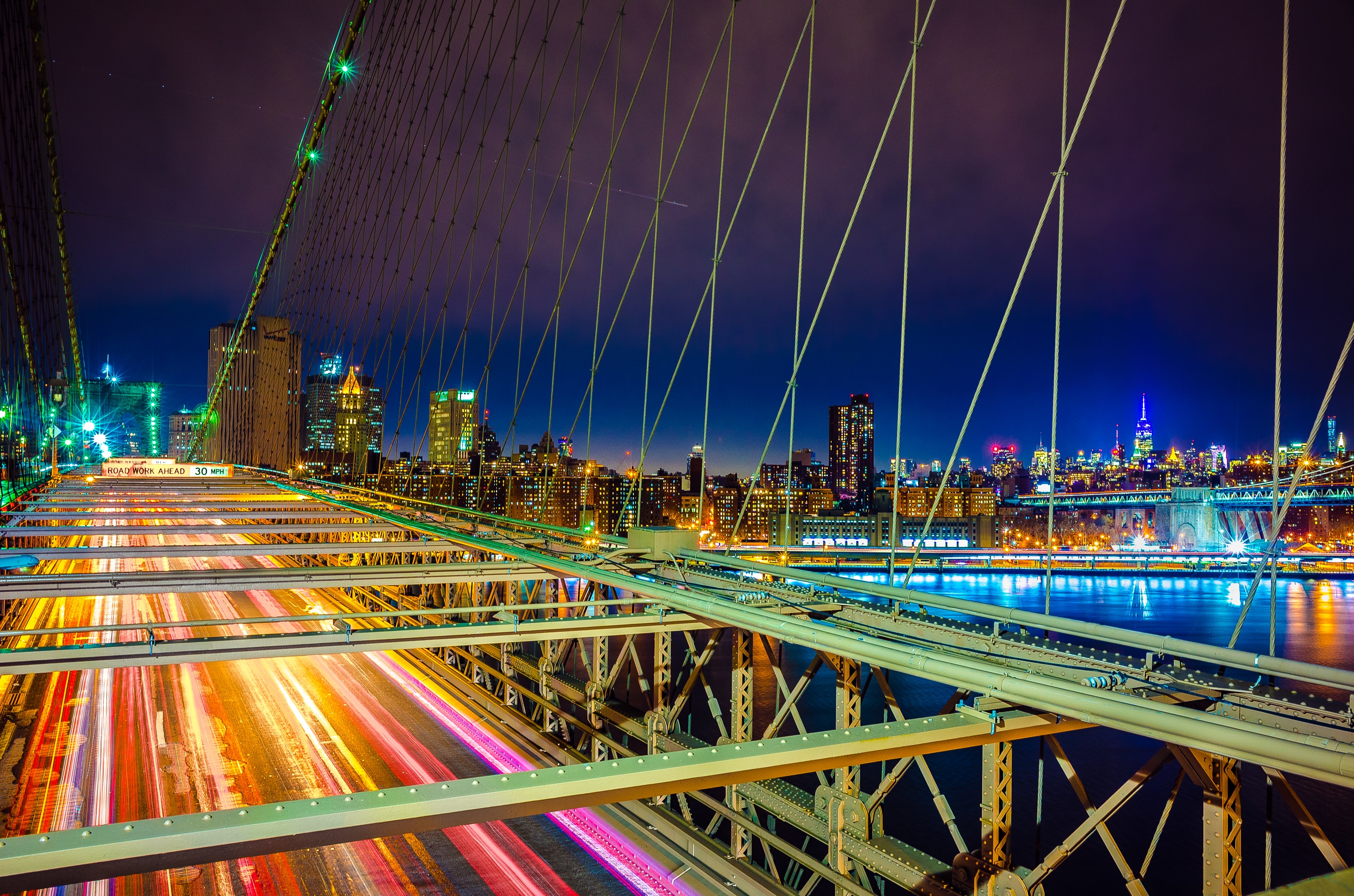 Brooklyn Bridge at night with city lights showing