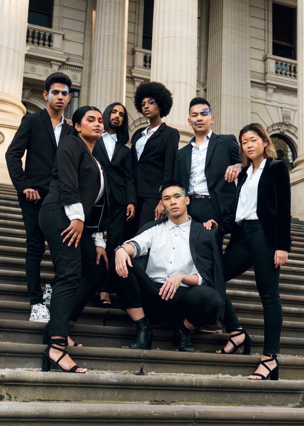 A group of models pose on staircase