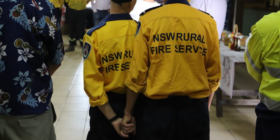 Two firefighters holding hands