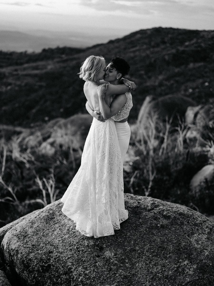 Two people kissing on their wedding day.