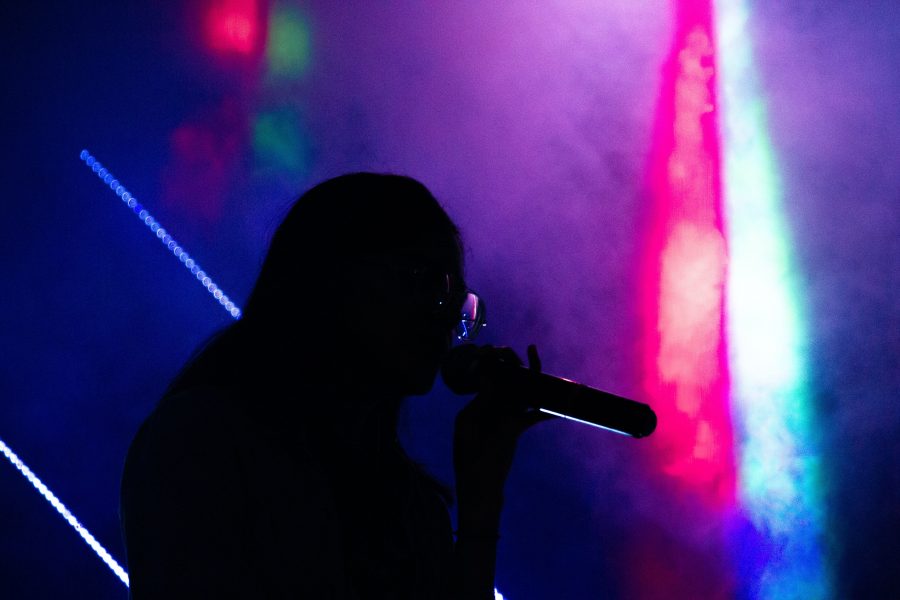 Silhouette of person holding a microphone
