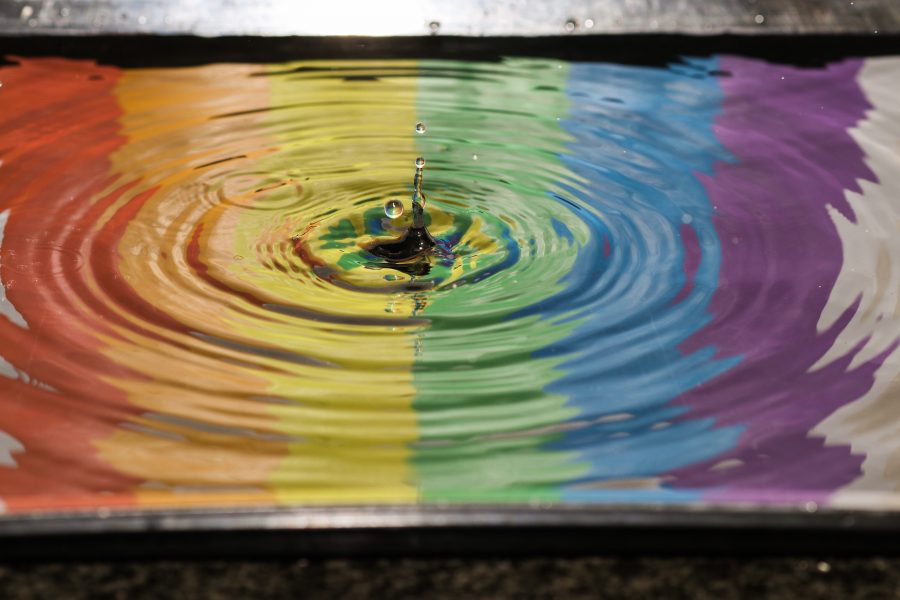 A time lapse photo of water over a reflection of a rainbow