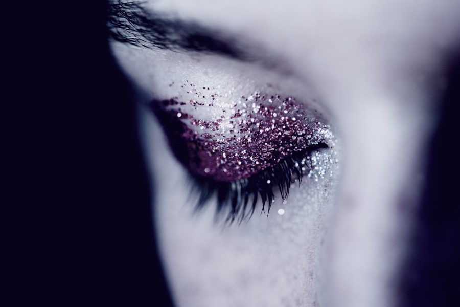 Person with glitter eyeshadow looking down