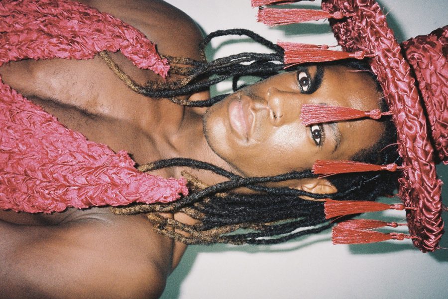 A person wearing a braided outfit and hat designed by Nathaniel Youkhana.