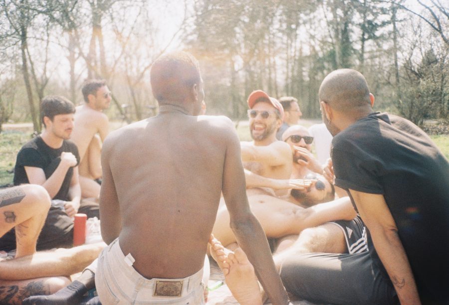 A candid shot of a group of friends laughing in the woods.