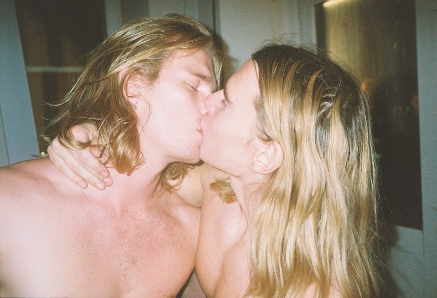 Two long-haired people kissing.