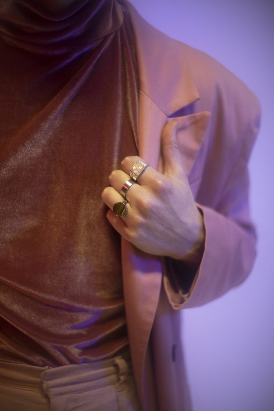 A close-up of Patrick's hands, with his jewellery showing.