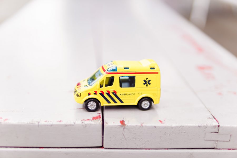 A yellow miniature ambulance toy.