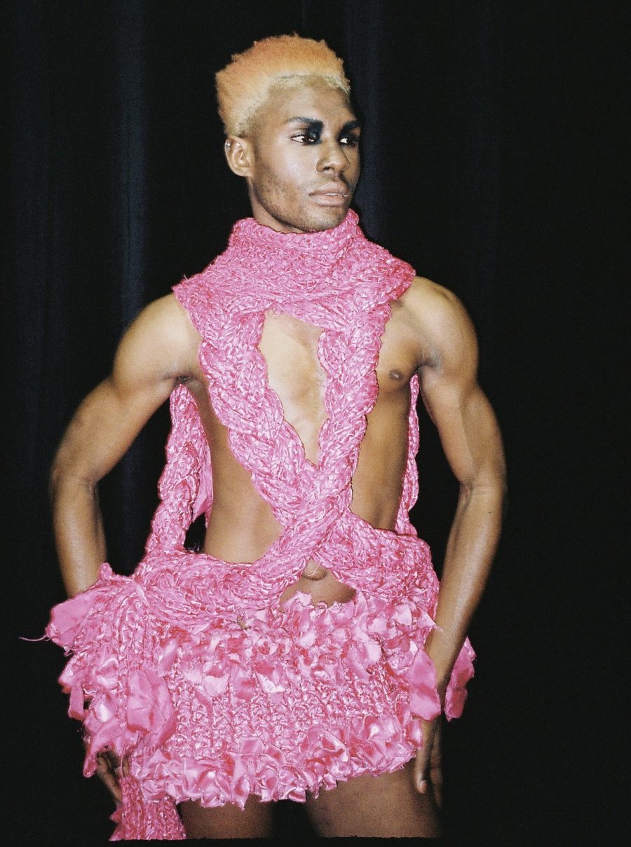 A person wearing a pink braided dress designed by Nathaniel.