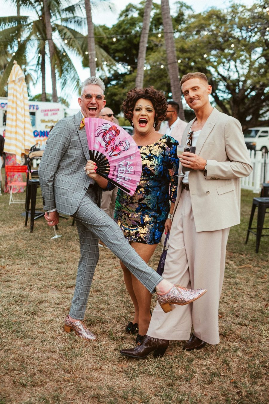 Three people feeling joyous at an event.