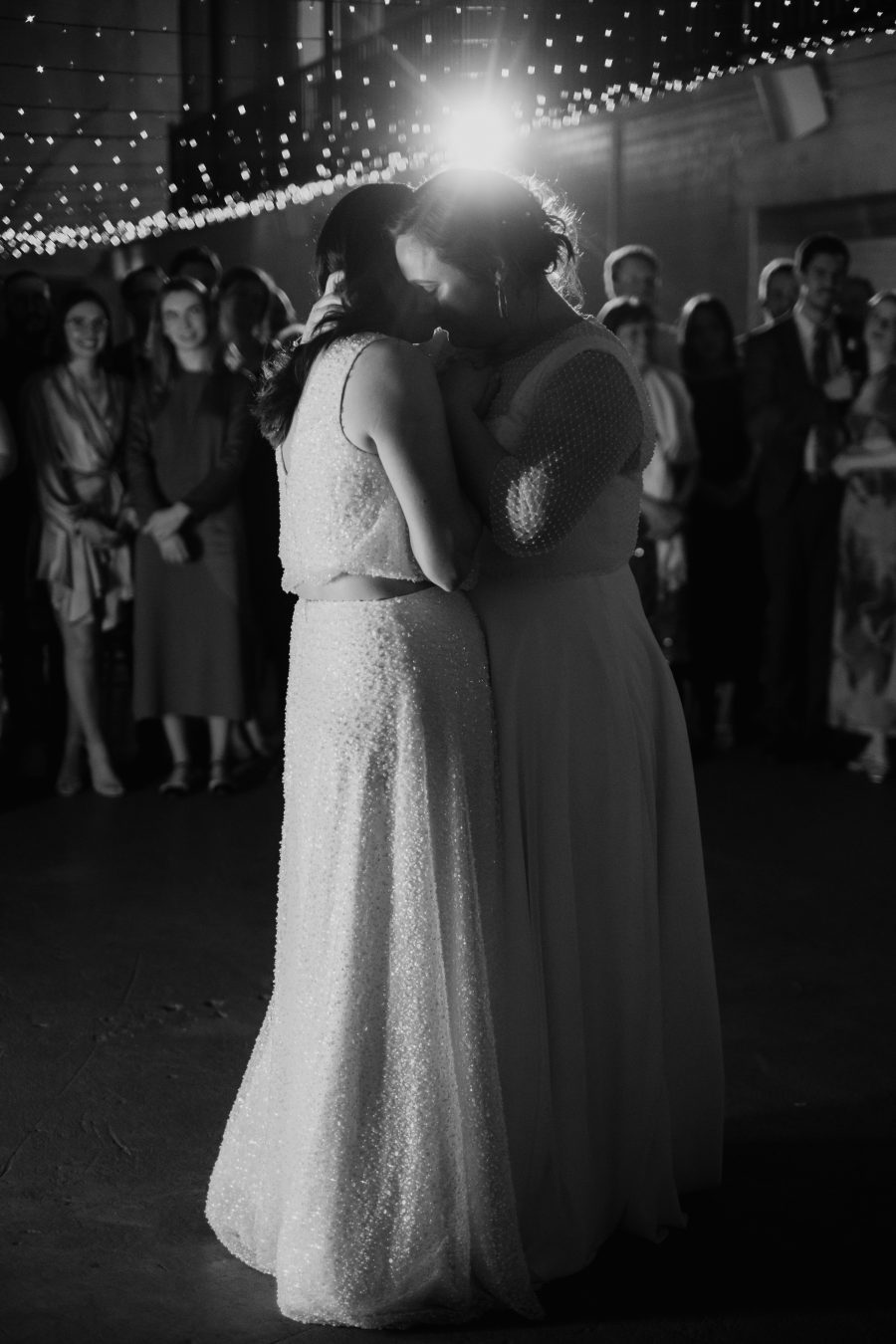 A queer couple dancing on their wedding day.