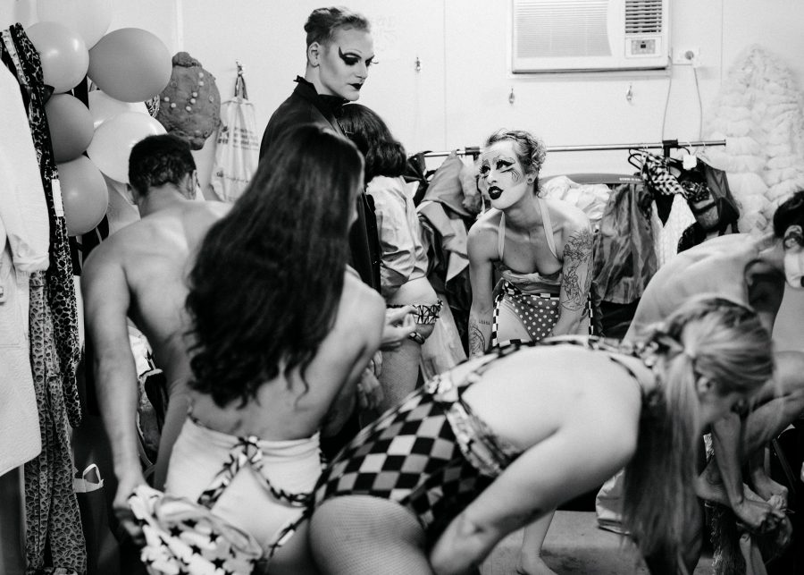 A group of queer performers, including drag artists, backstage.