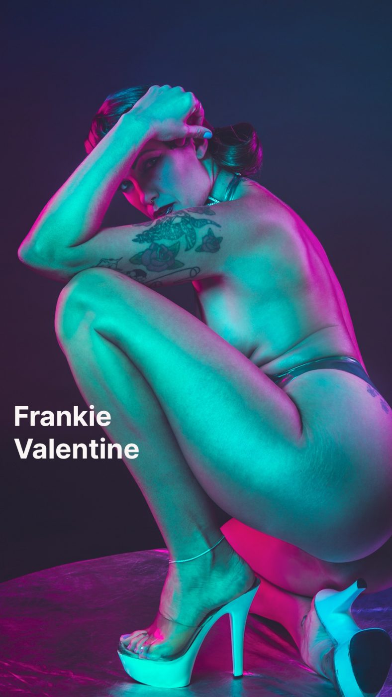 Frankie Valentine in high heels and mood lighting.