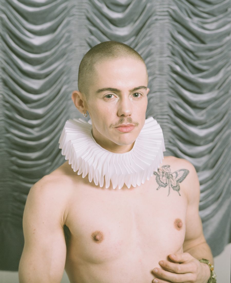 A shirtless person in a frilly Victorian collar.