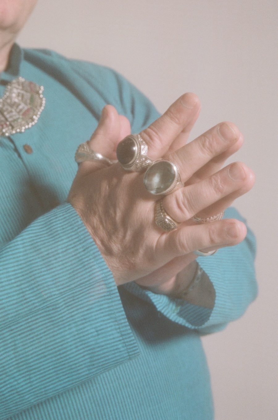 A close-up photo of Eden's hands with chunky jewellery. From Foreground: Portraits of Older Transgender and Gender Diverse People