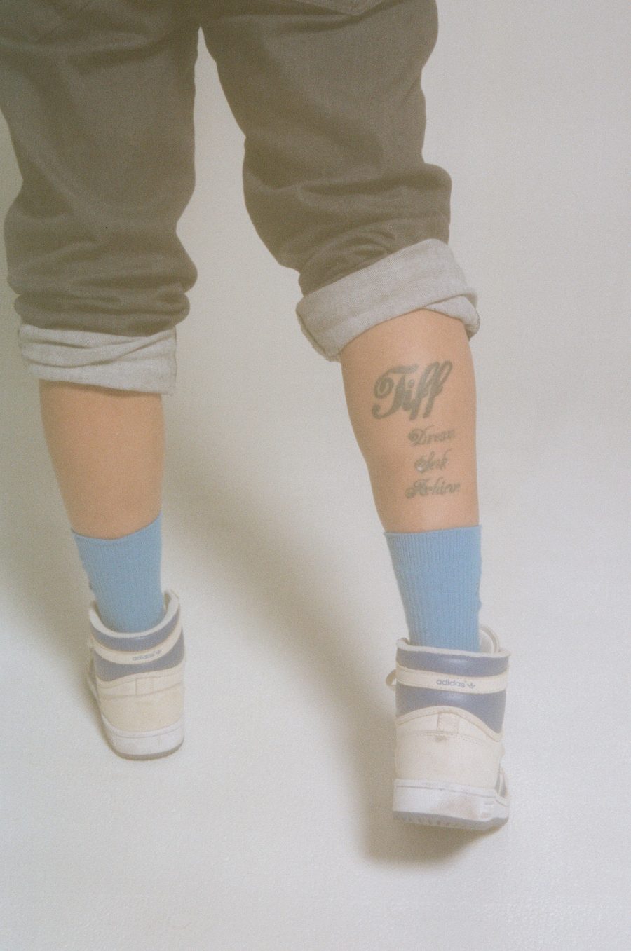 The back of Tiff's tattooed legs.