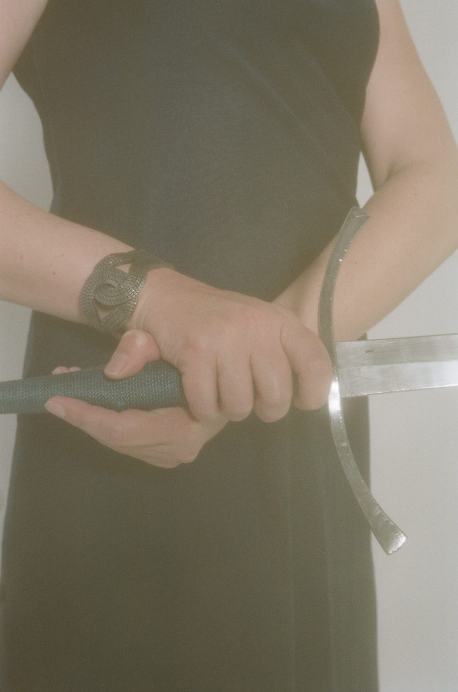 A close-up of Imogen's hands holding a sword. From Foreground: Portraits of Older Transgender and Gender Diverse People