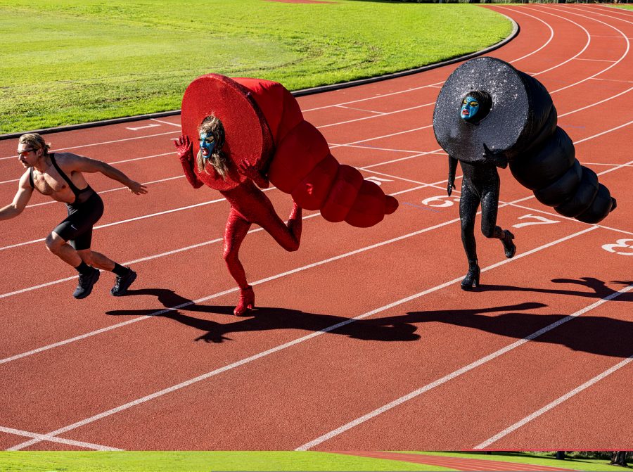 Will and Garrett running on a track dressed as sex toys.