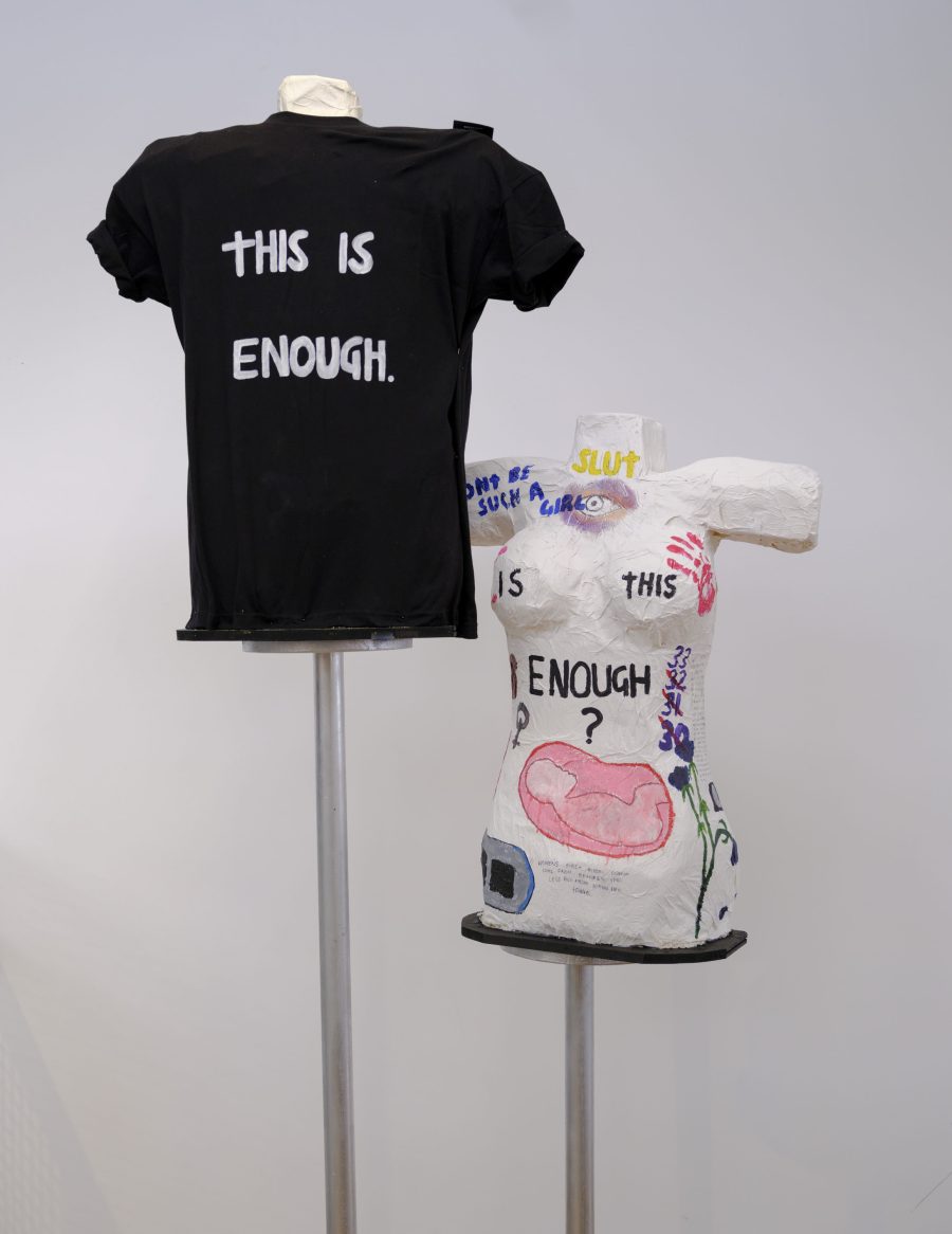 Tshirt that says "This is enough" alongside a naked bust that say "Is this enough?".