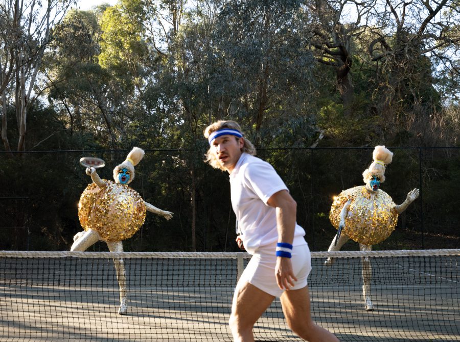 Will and Garrett as giant tennis balls playing tennis.