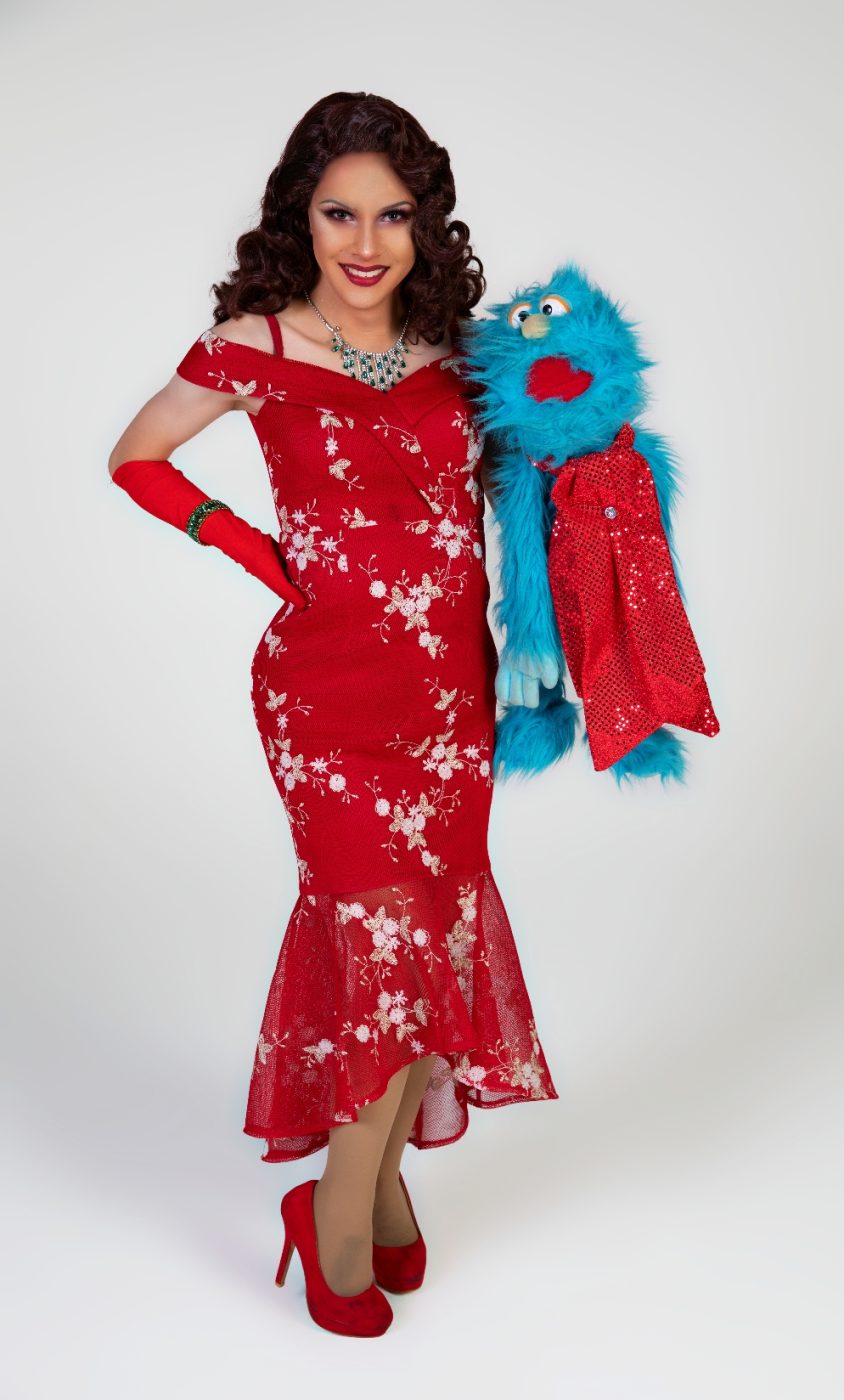 Linh Uendo in drag, with a puppet.