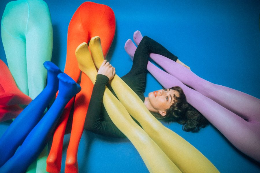 Magnets, aka Siobhan McGinnity, in a pile of colourful mannequin legs.