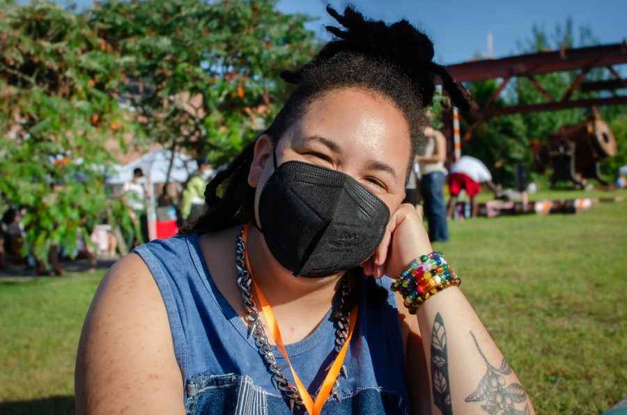 Des Bennett sitting on the lawn at the Queer/Trans Zine Fest.