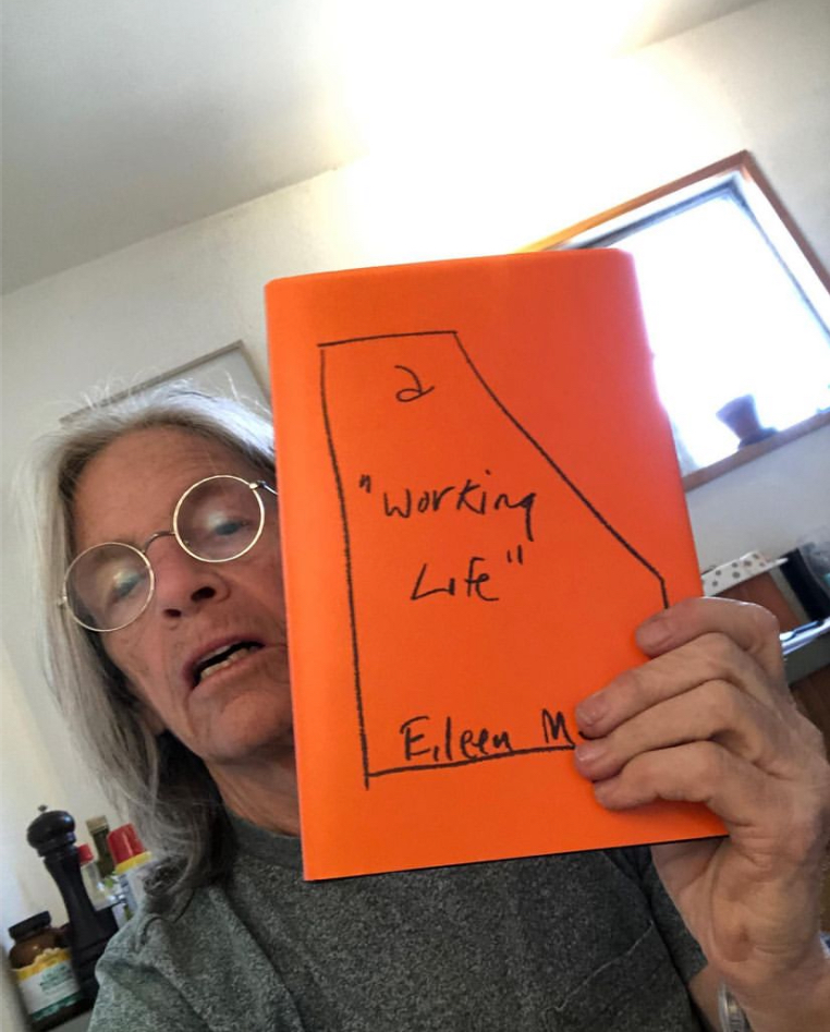 'a "Working Life"', a book with an orange cover.