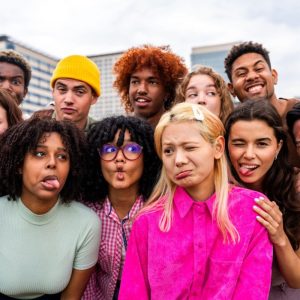 A group of people making different facial expressions.