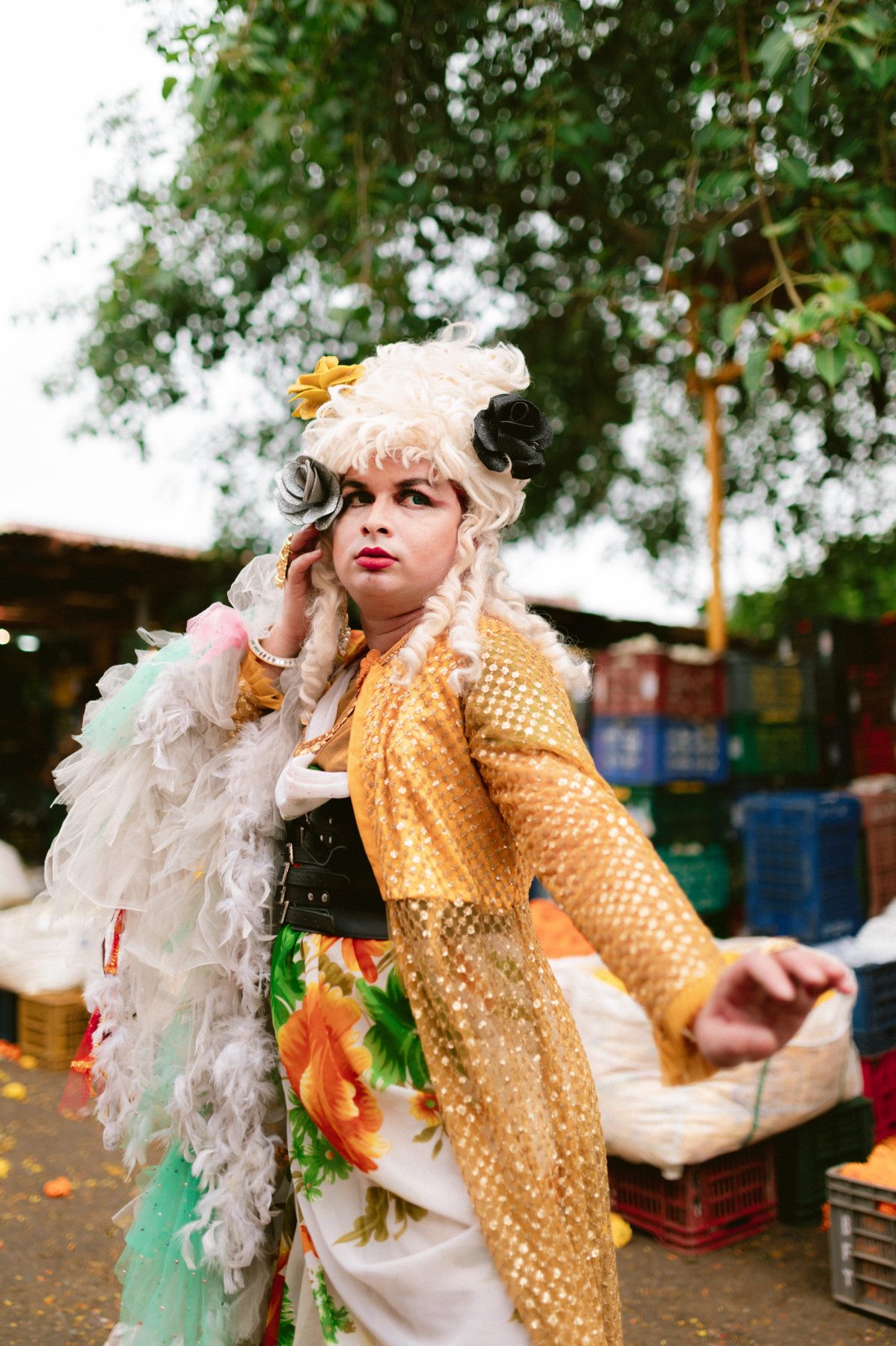 Patruni dancing in the market aisle in their floral drag.