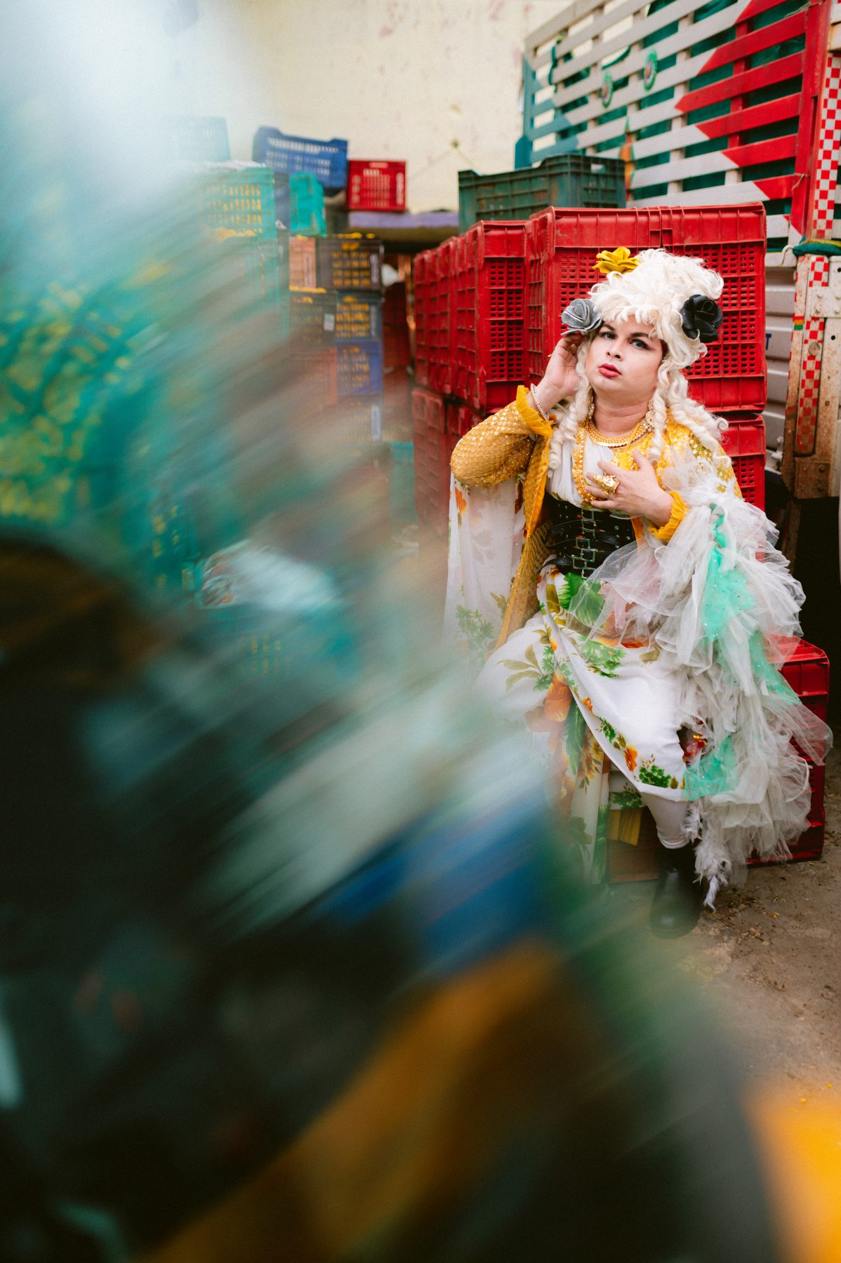 Patruni poses among flower pallets.
