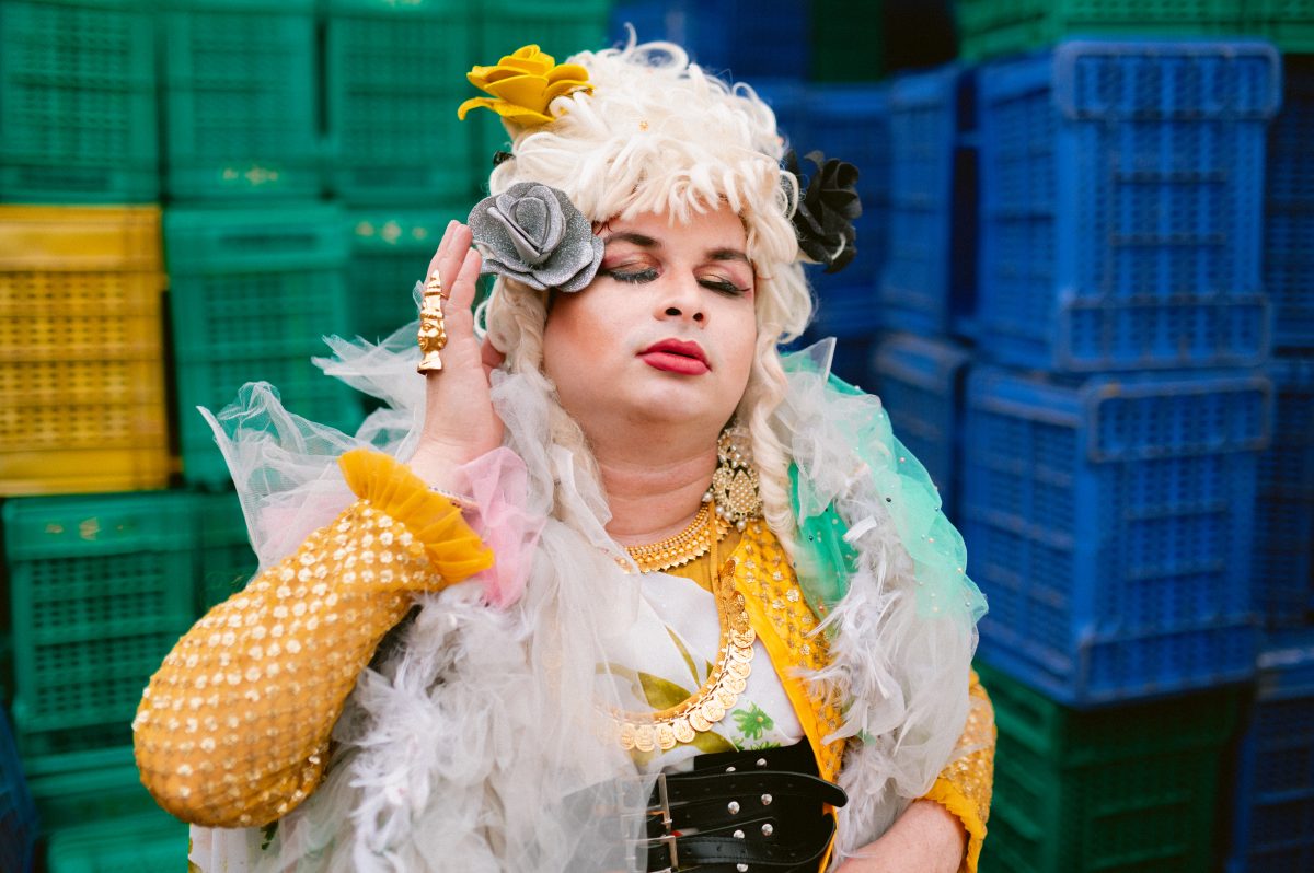 Patruni, the author, at Hyderabad's flower market in opulent, regal drag.