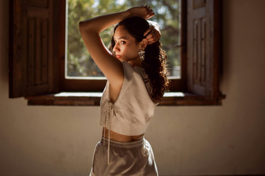A person in hyper-feminine, 'cottagecore' fashion, to celebrate queer femininity.