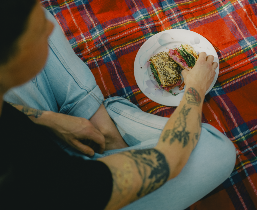 Erin Riley eating food on a picnic blanket.